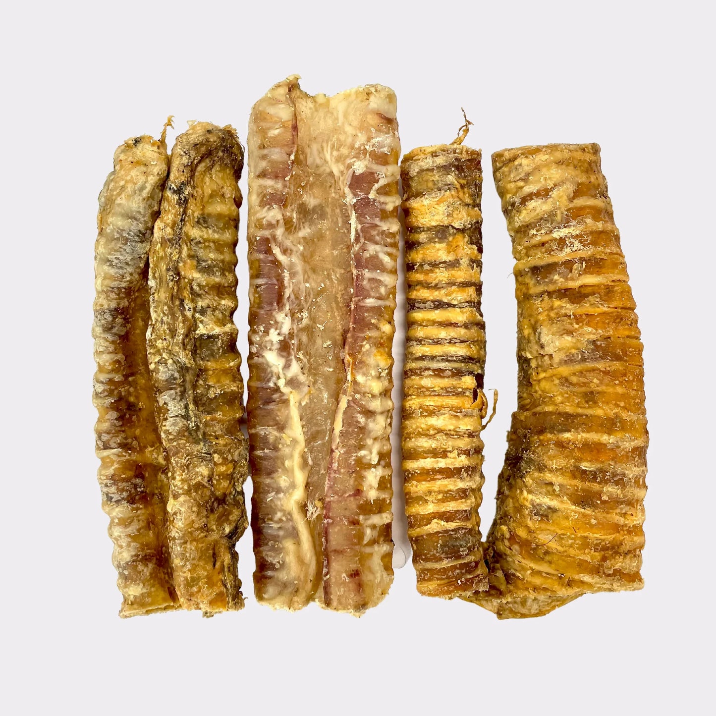 Five Hilltop Pet Food Moo Tubesâcow trachea dog treatsâarranged vertically on a plain white background.