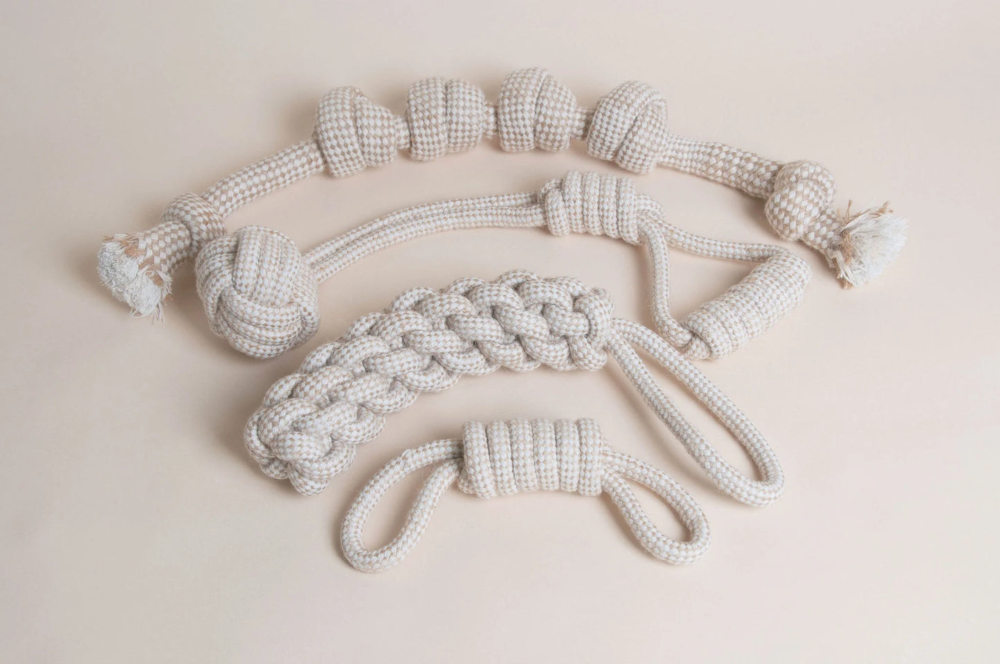 Hilltop Pet Food Rope Toys - Tugs and Kisses: Set of 4 eco-friendly cream & white dog tug toys on a beige surface.