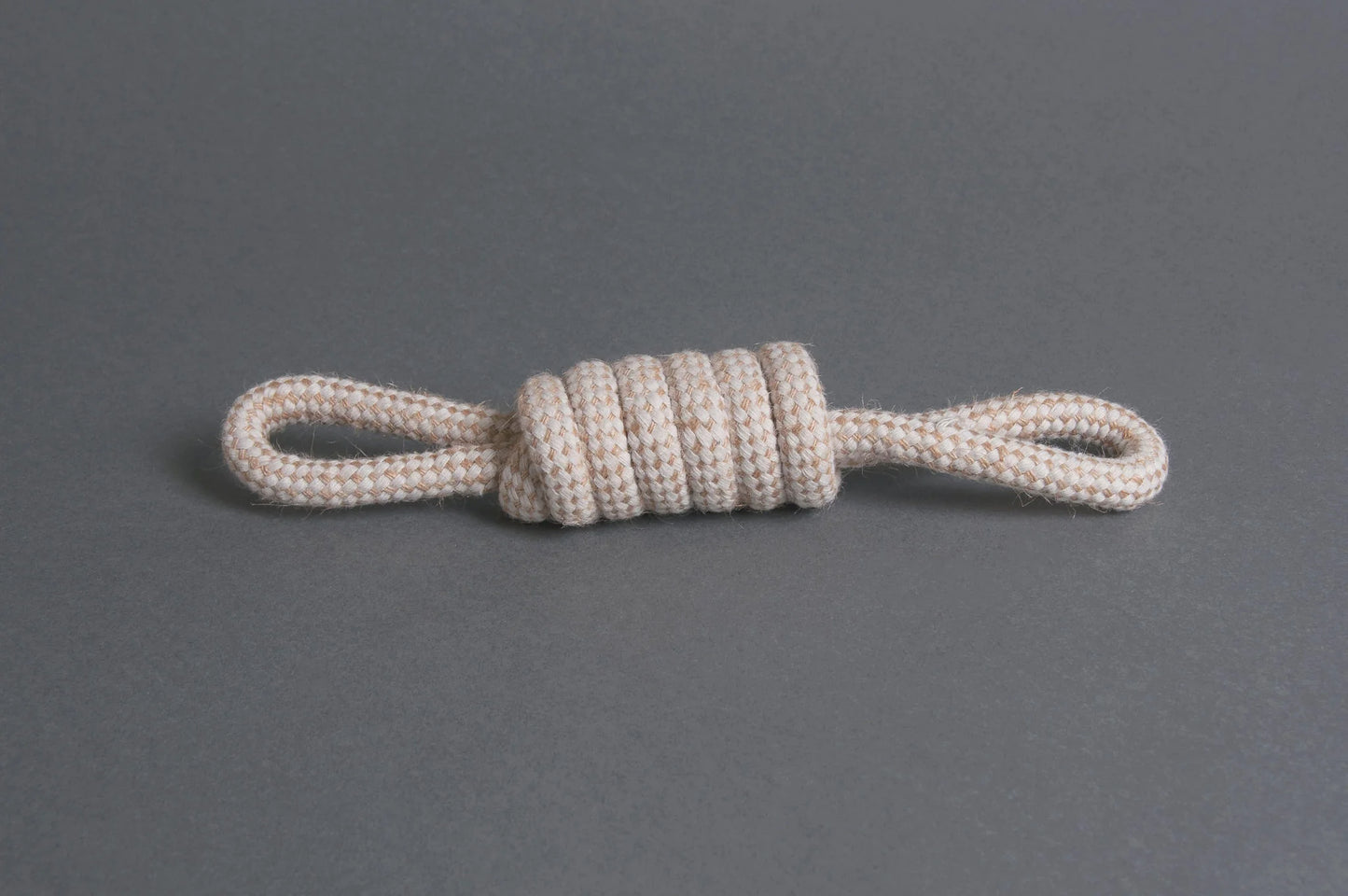 The Hilltop Pet Food Natural Rope Toy - Bow Tie Tug is a white, knotted organic toy with loops at both ends.