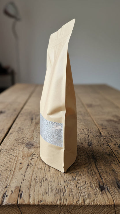 side view of 2kg bag of oyster shell grit on a wooden surface