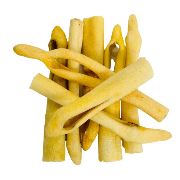 Hilltop Pet Food Beef Tail—hollow, yellow, tube-shaped natural dog chews stacked on a white background.