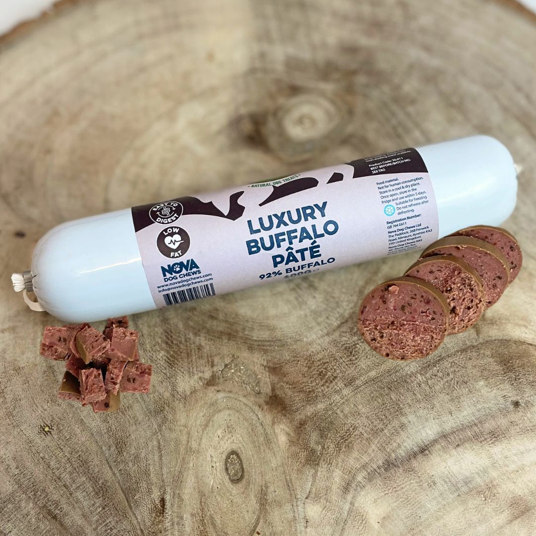 Hilltop Pet Food Paddock Farm Luxury Pâté for dogs and cats, sliced on wood with cubed and round pieces.