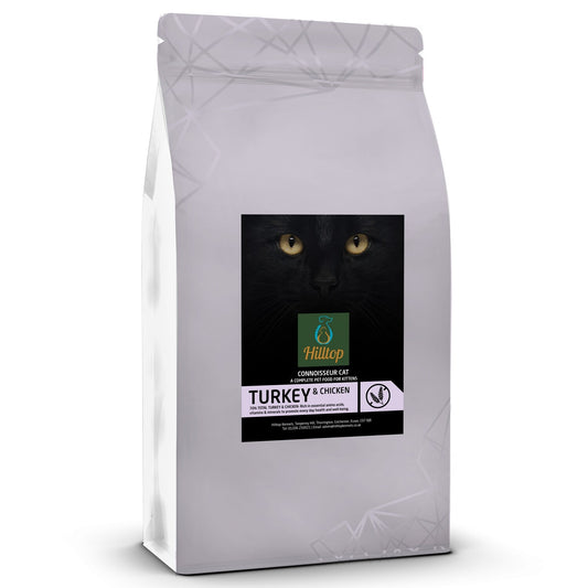 A white bag of Hilltop Pet Food Connoisseur Kitten Turkey and Chicken cat food with a black cat on the label.