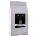 Silver coffee bag with a label showing a black cat’s eyes and green text, standing upright on a plain background.