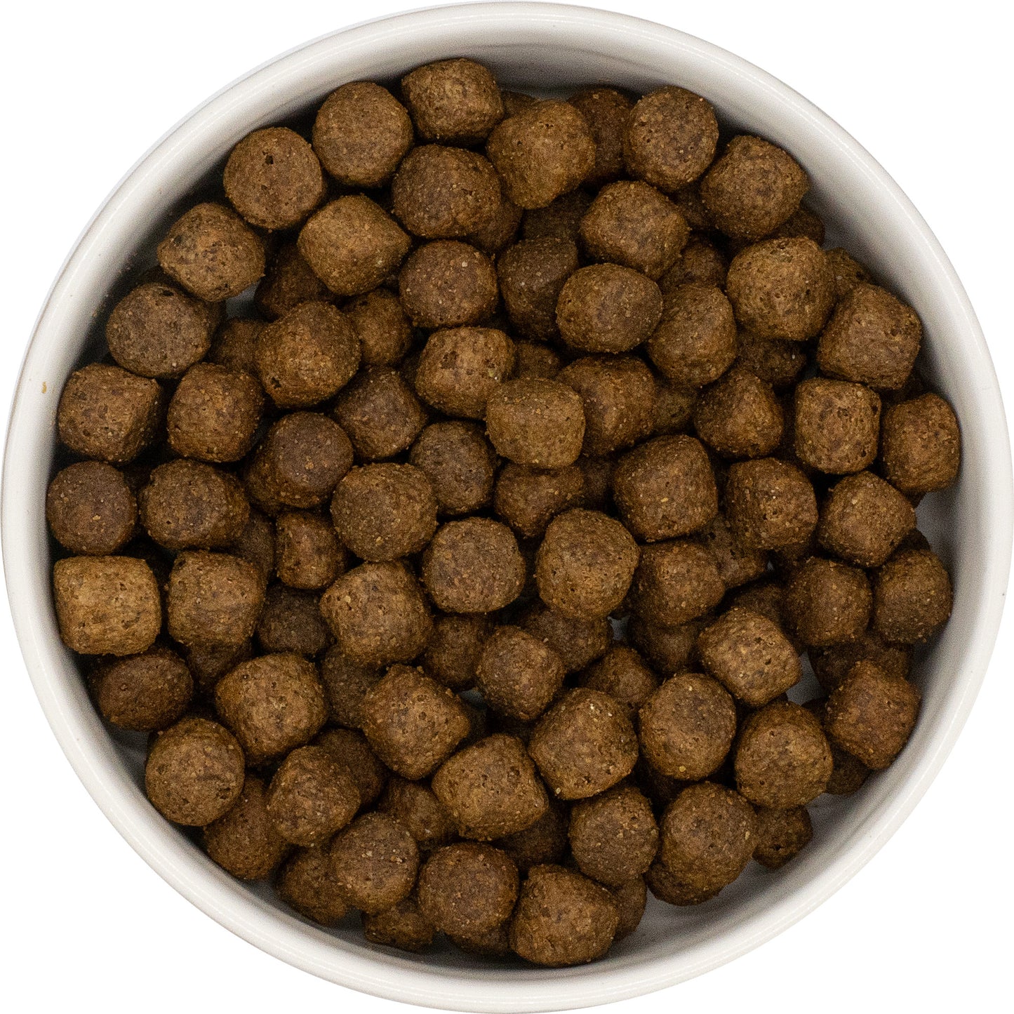 A white bowl filled with Hilltop Super Premium Adult Dog Food - Duck & Potato kibble, viewed from above.