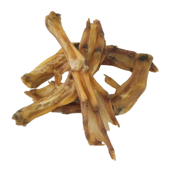 A pile of Hilltop Pet Food Duck Feet dog treats—natural chews and a tasty chicken feet alternative—on white background.