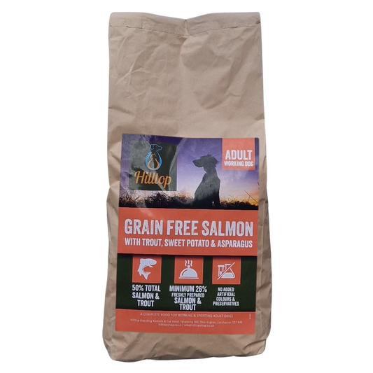 Bag of Hilltop grain-free dog food with salmon, trout, sweet potato, and asparagus ingredients on a white background.