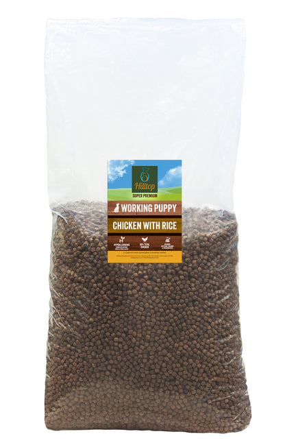 A large clear bag of Hilltop Pet Food Super Premium PUPPY Chicken & Rice, showing brown kibble inside.
