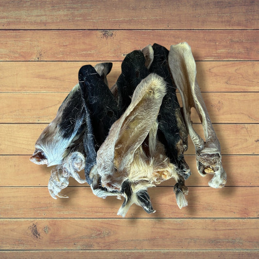 Hilltop Pet Food Furry Lamb Ears rest on wood—a natural, wholesome dog treat choice.