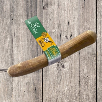Hilltop Pet Foods goodWood Coffee Wood Chewable Stick is a natural dental treat for dogs, shown on a wooden surface.