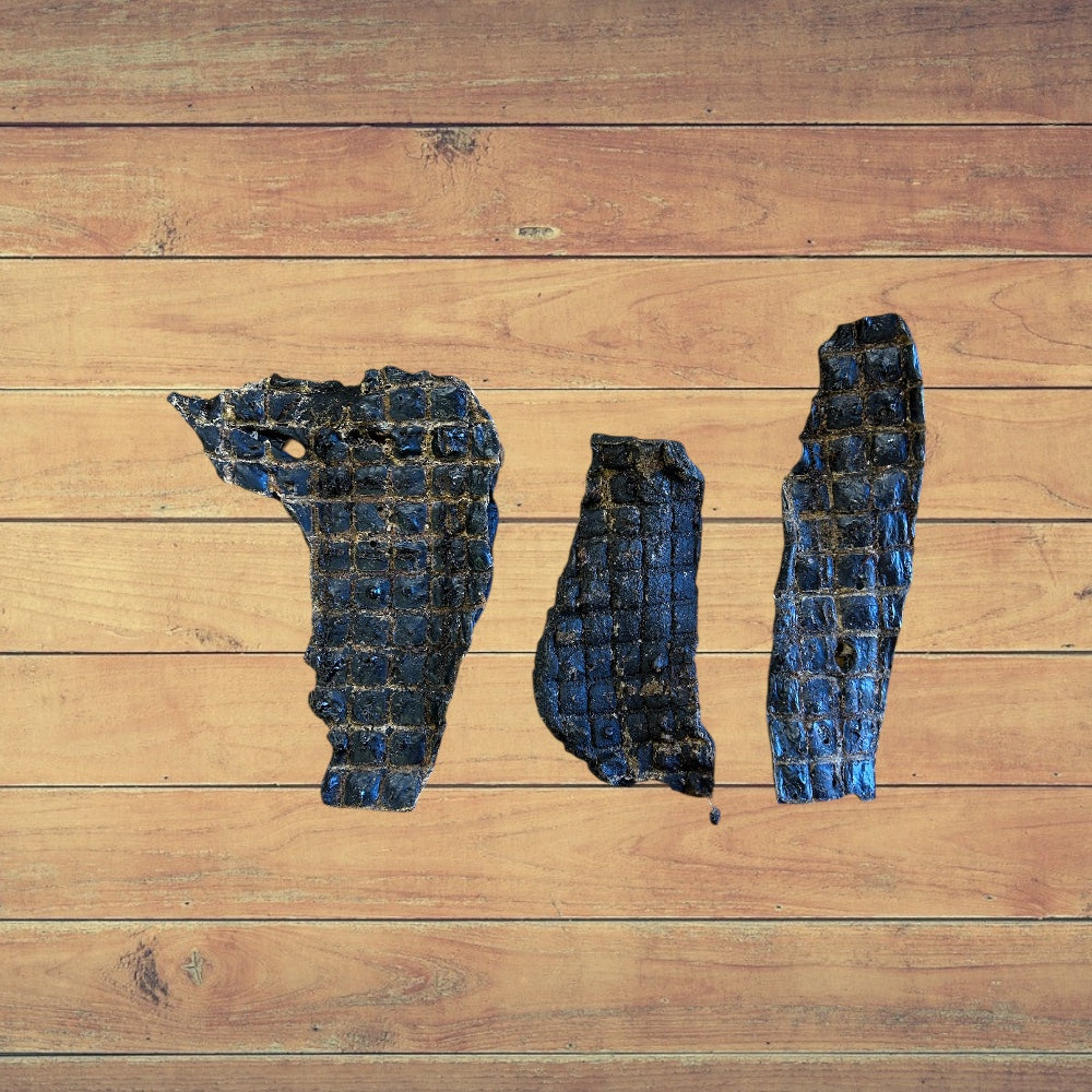 3 Beef Spleen dog treat pieces on a wooden surface