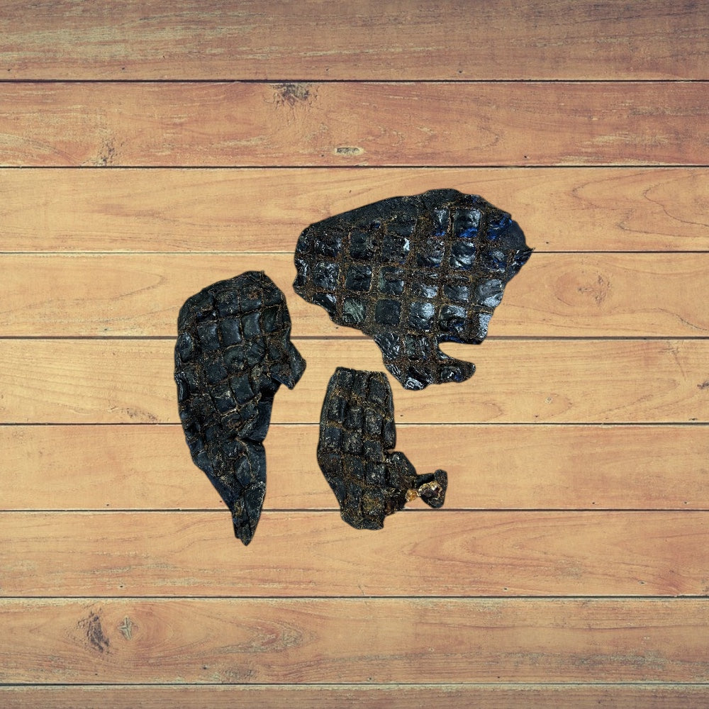 3 small pieces of Beef Spleen dog treats on a wooden surface