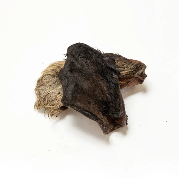 Hilltop Pet Food Hairy Cow Ears: a natural, low-fat dog chew with fur, shown on a plain white background.