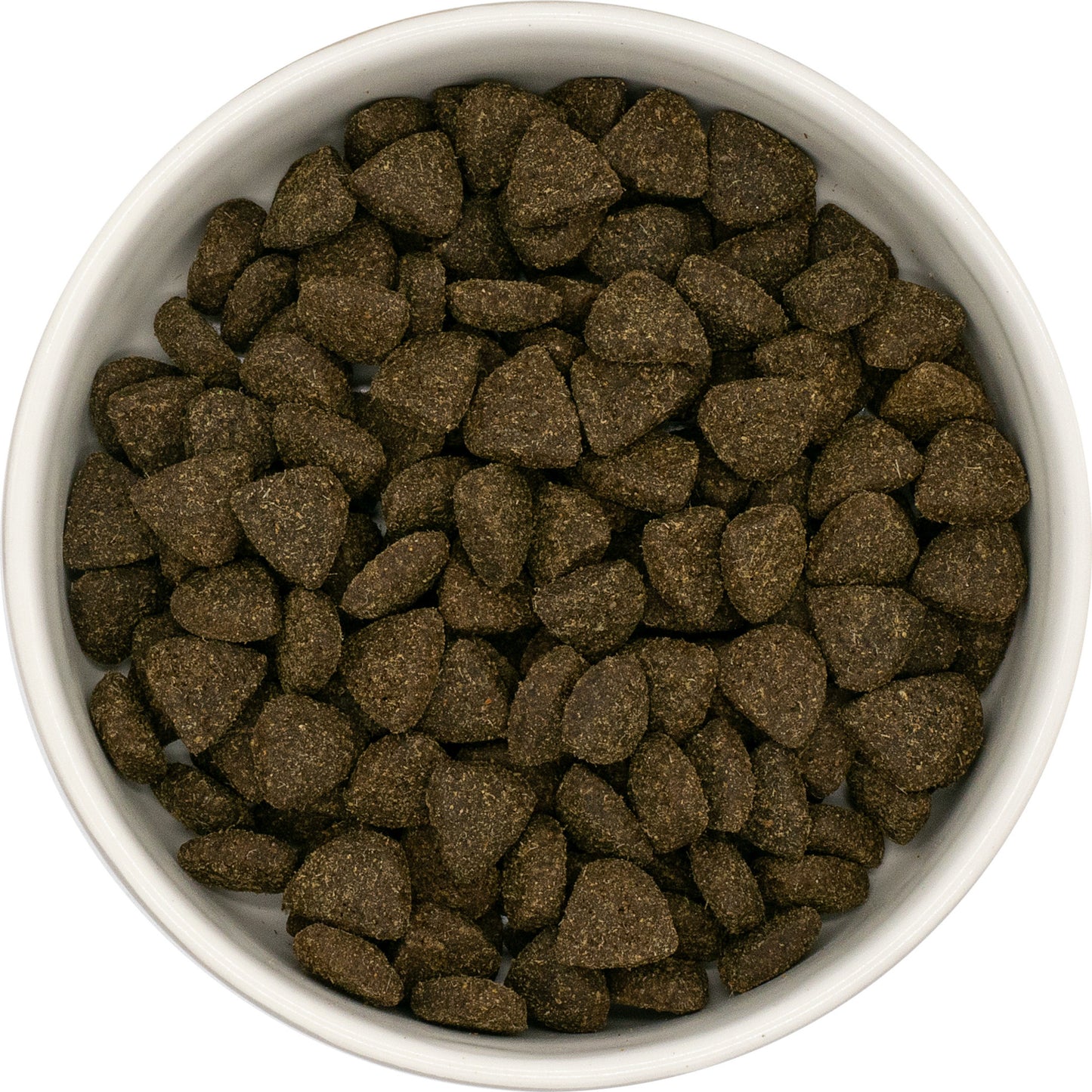 A white bowl filled with Hilltop Superfood 65 Adult Dog Food—grain-free, grass-fed lamb kibble with fruits & veggies.
