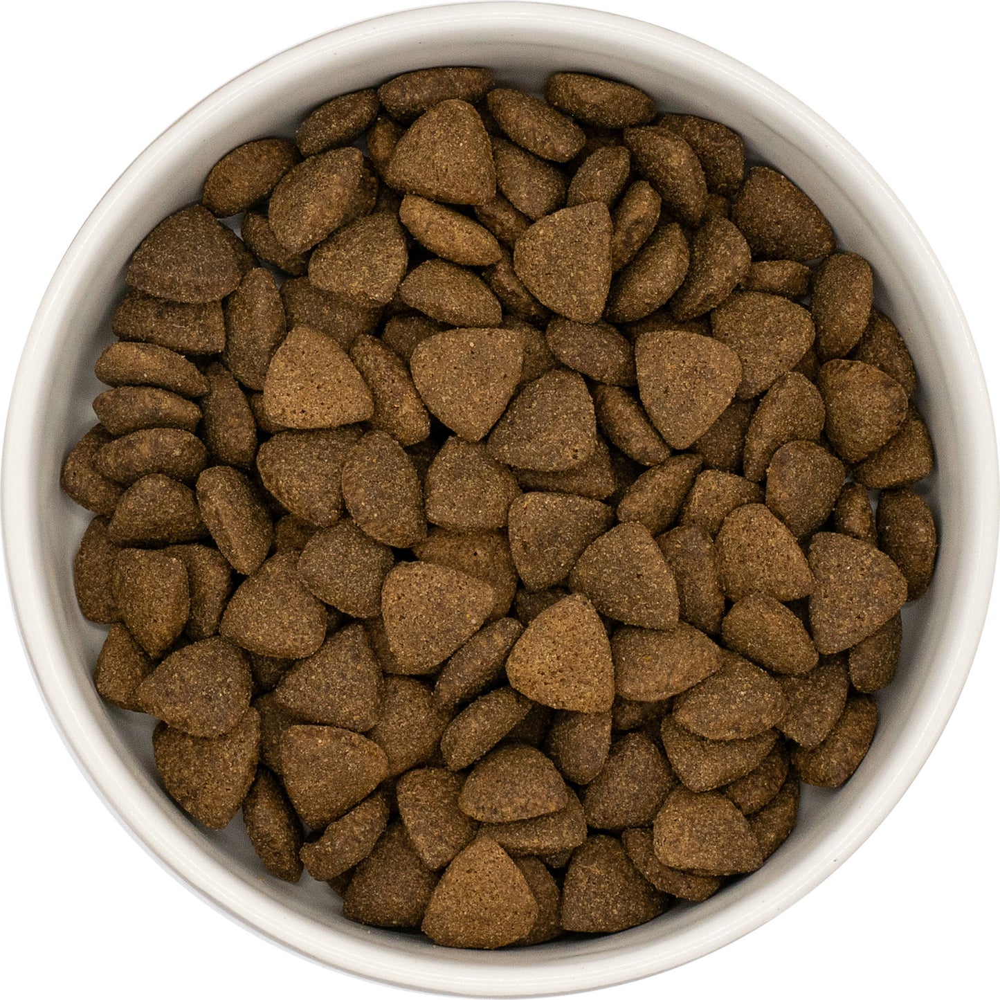 A white bowl filled with Hilltop Superfood 65 Angus Beef dog food made with parsley, papaya, nettle, zucchini & pumpkin.