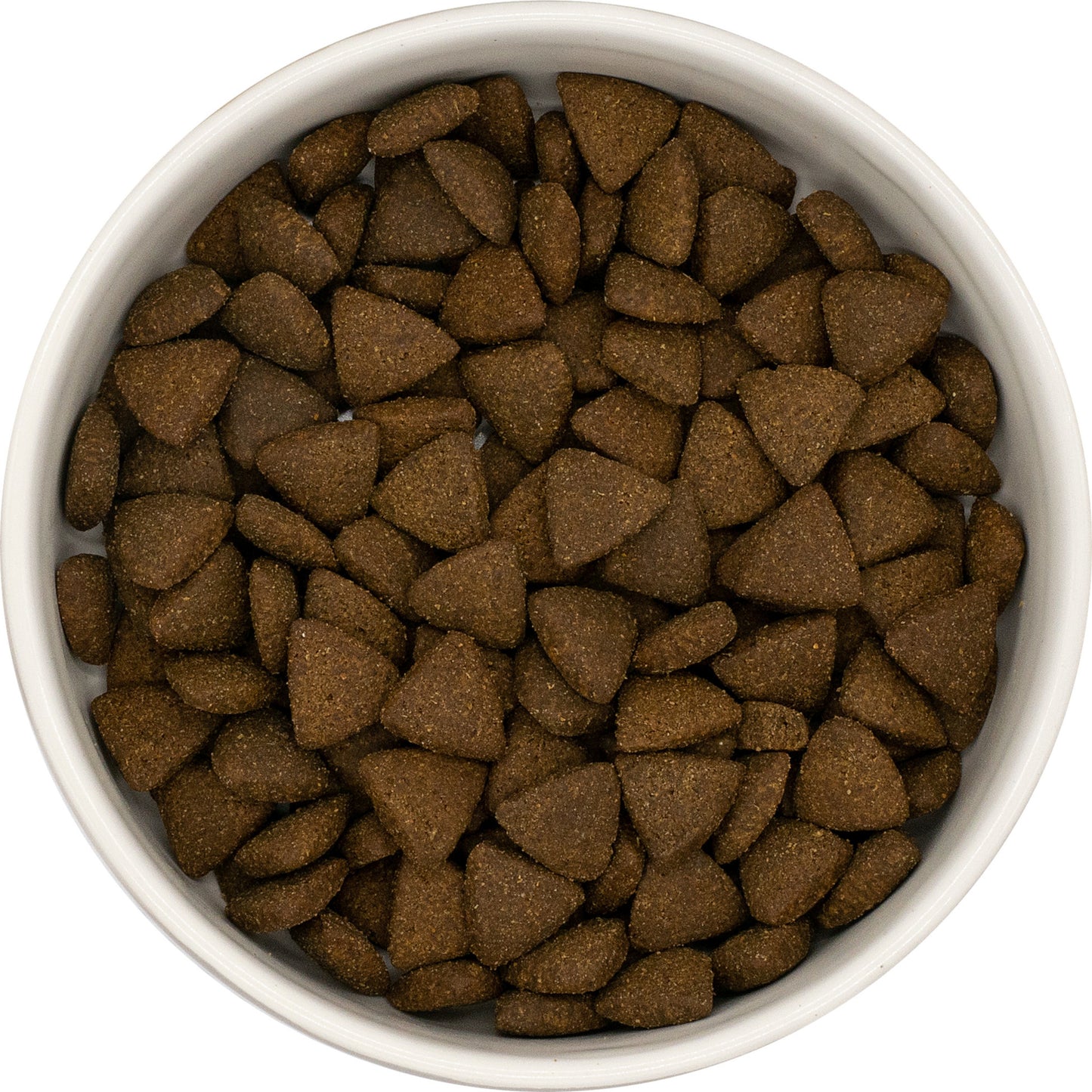 A white bowl of Hilltop Pet Food Superfood 65 Adult Dog Food with turkey, pork, parsley, papaya & more, seen from above.