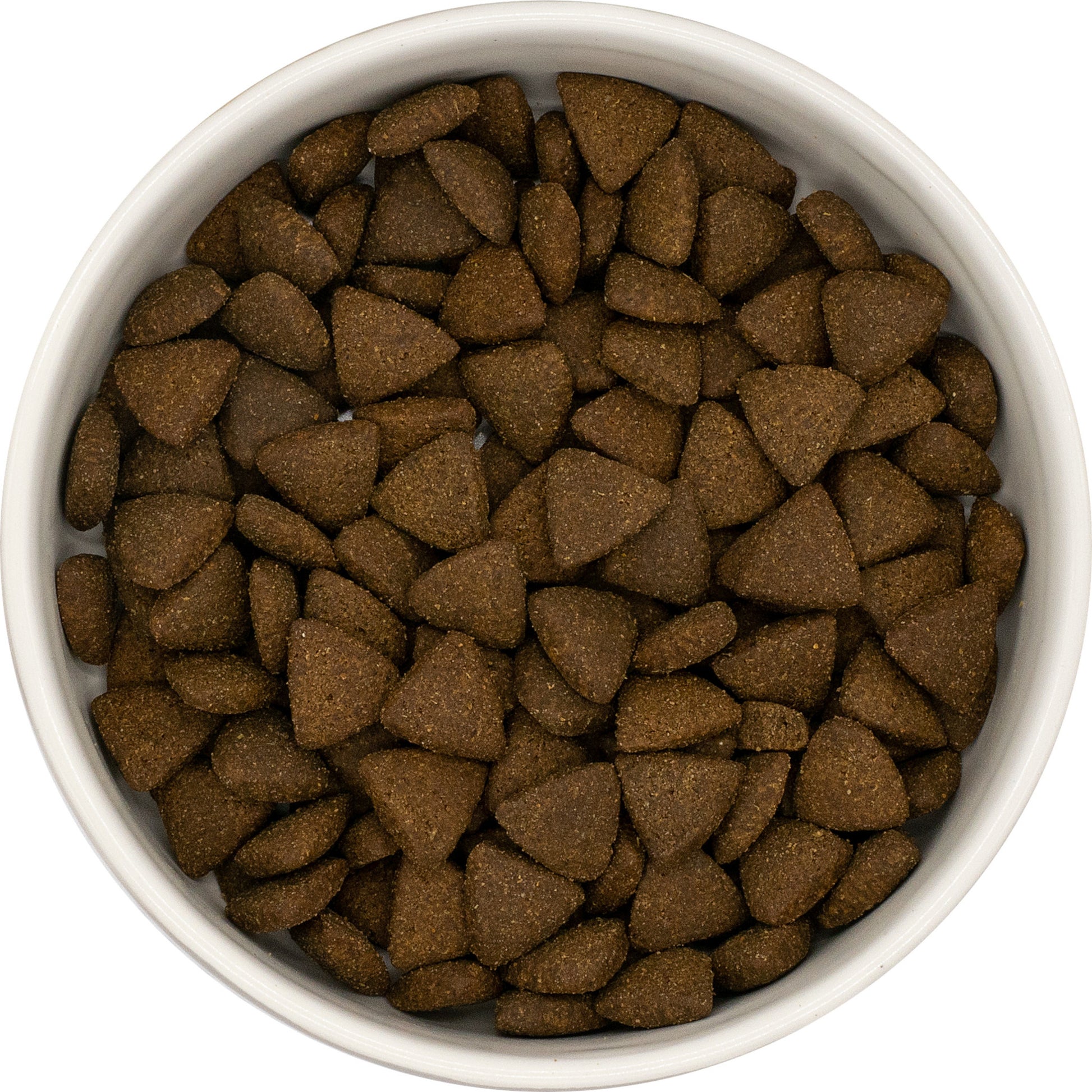 A white bowl of Hilltop Pet Food Superfood 65 Adult Dog Food with turkey, pork, parsley, papaya & more, seen from above.