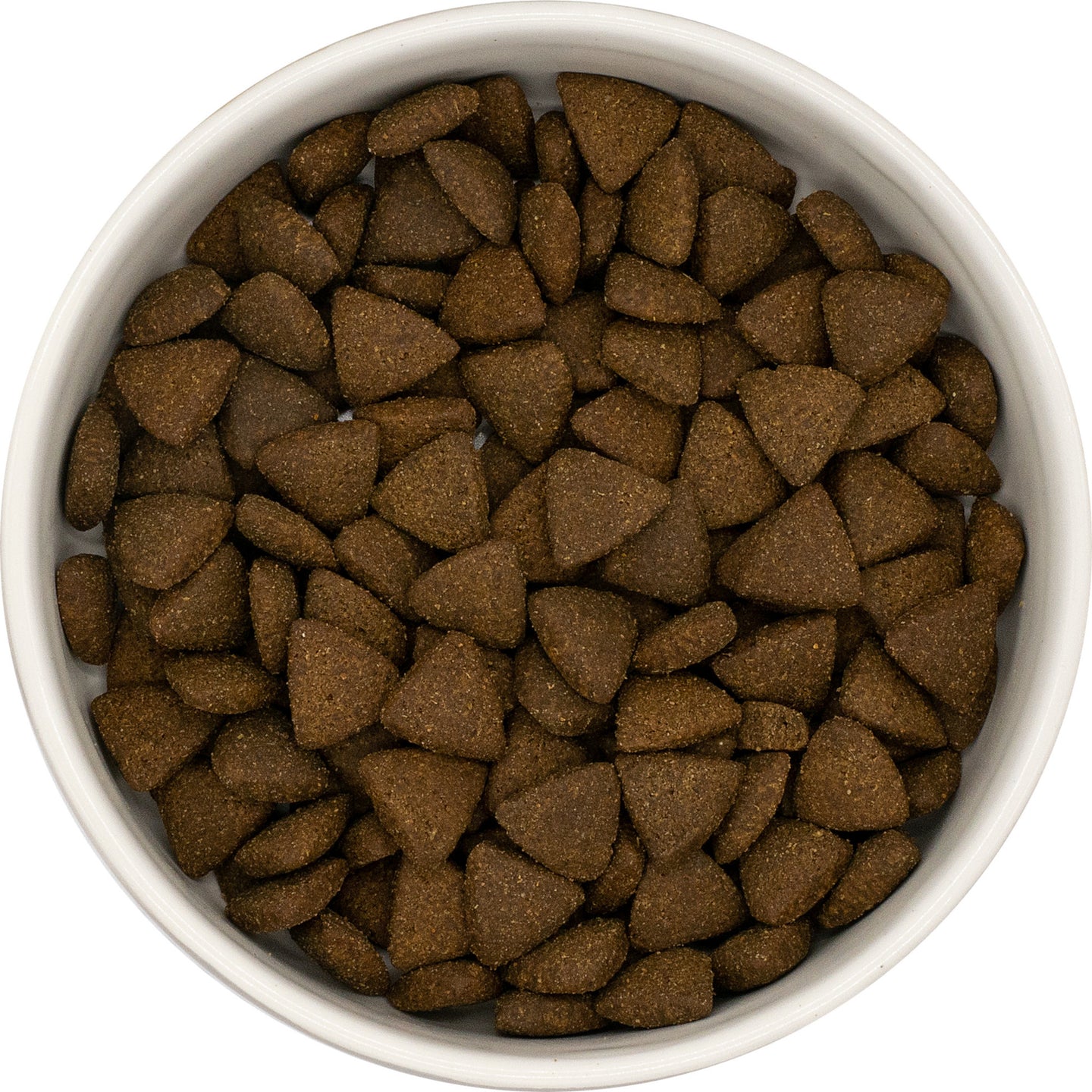 A white bowl of Hilltop Pet Food Superfood 65 Adult Dog Food with turkey, pork, parsley, papaya & more, seen from above.