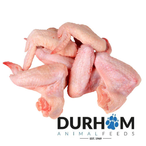 Raw duck wings from Hilltop Pet Food piled above the Durham Animal Feeds logo with a paw print replacing the A in DURHAM.