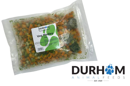 A sealed 1kg bag of Hilltop Pet Food Durham Free Flow Vegetable Medley next to the paw print company logo.