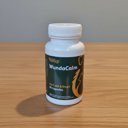 Plastic container of WundaCalm 50 x capsules on a wooden surface