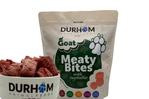 A 1kg bag of Hilltop Pet Food Durham Meaty Bites Goat with Veg & Supplements next to a filled bowl.