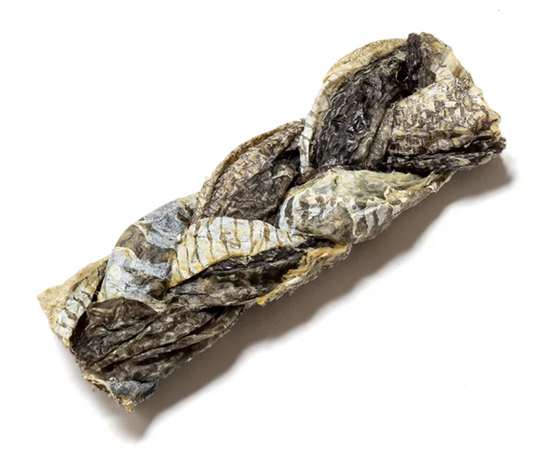 Hilltop Pet Food Fish Skin Braids, natural dog treats with a scaly texture, lying on a white background.
