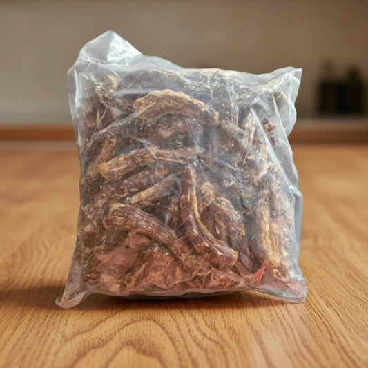 Bag of dried chicken necks on a wooden background