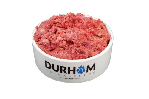 A white bowl labeled Hilltop Pet Food filled with Durham (DAF): Lamb Mince 454g raw dog food, on a white background.