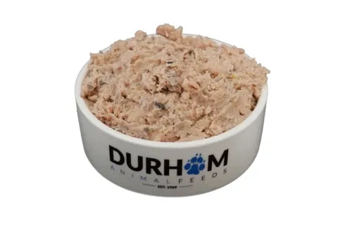 A white bowl labeled Hilltop Pet Food filled with pinkish Durham (DAF): Oily Fish Mince 454g dog food.