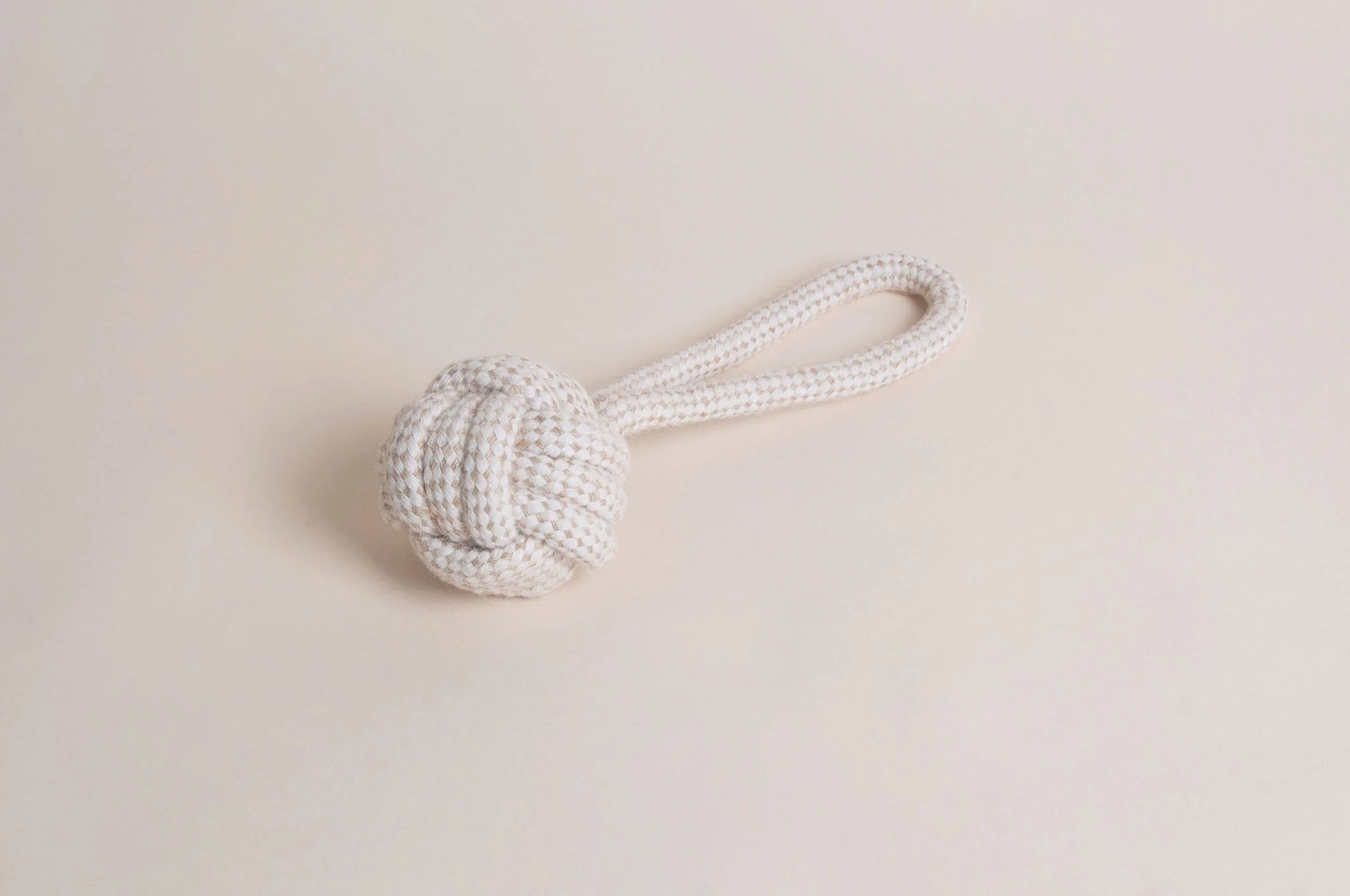 The Hilltop Pet Food Natural Rope Toy - Slingshot Ball features a knotted ball and looped handle on beige.