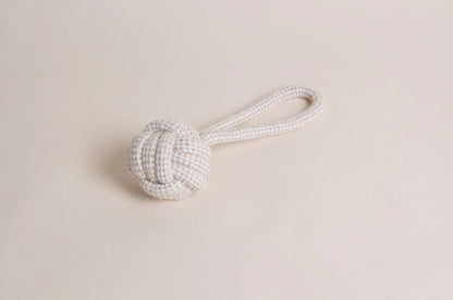 The Hilltop Pet Food Natural Rope Toy - Slingshot Ball features a knotted ball and looped handle on beige.