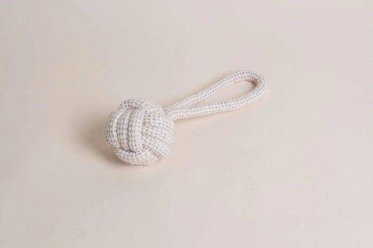 The Hilltop Pet Food Natural Rope Toy - Slingshot Ball features a knotted ball and looped handle on beige.