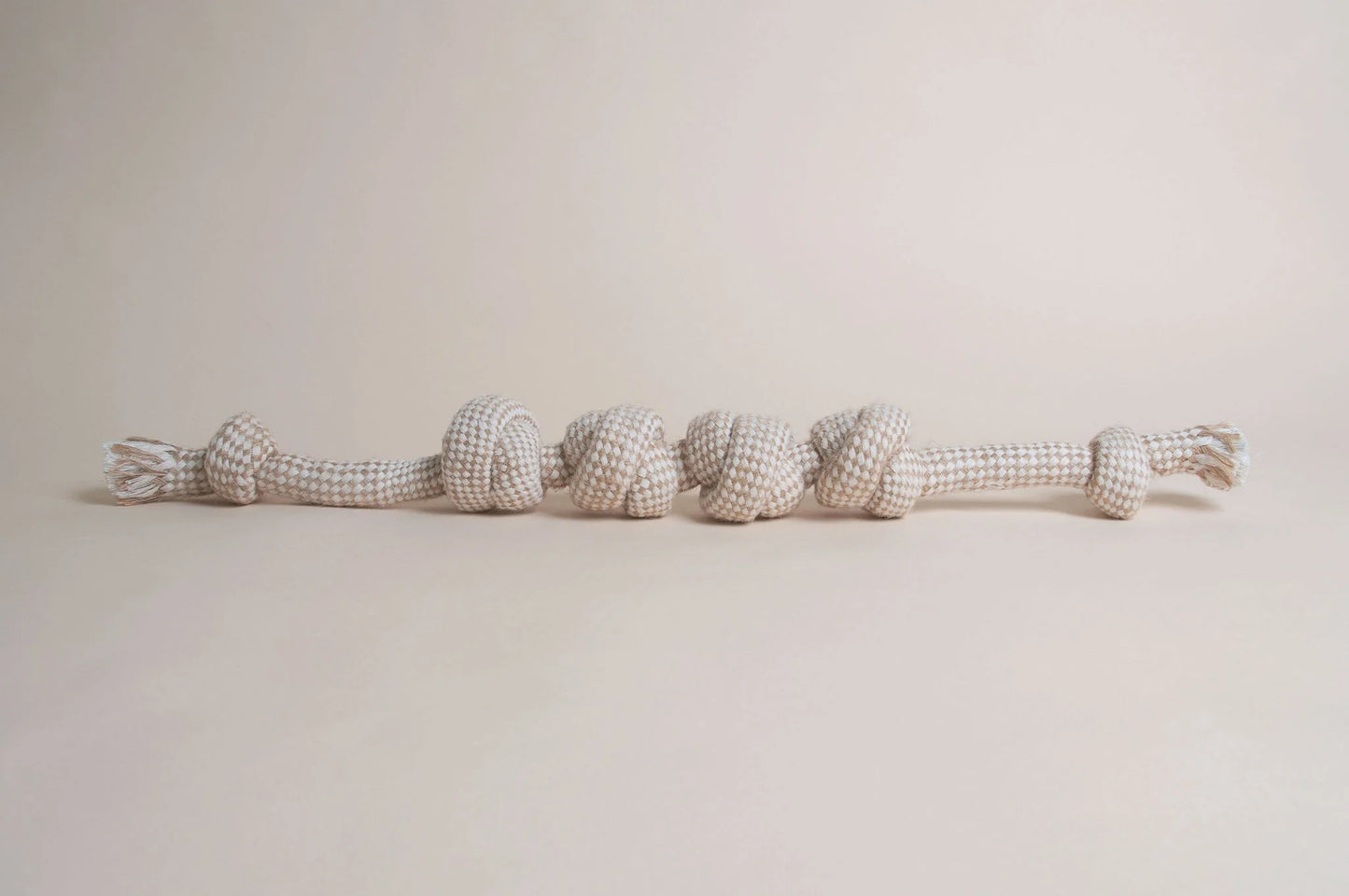 The Hilltop Pet Food Natural Rope Toy - Knotty But Nice Tug, in beige and white, sits on a neutral background.