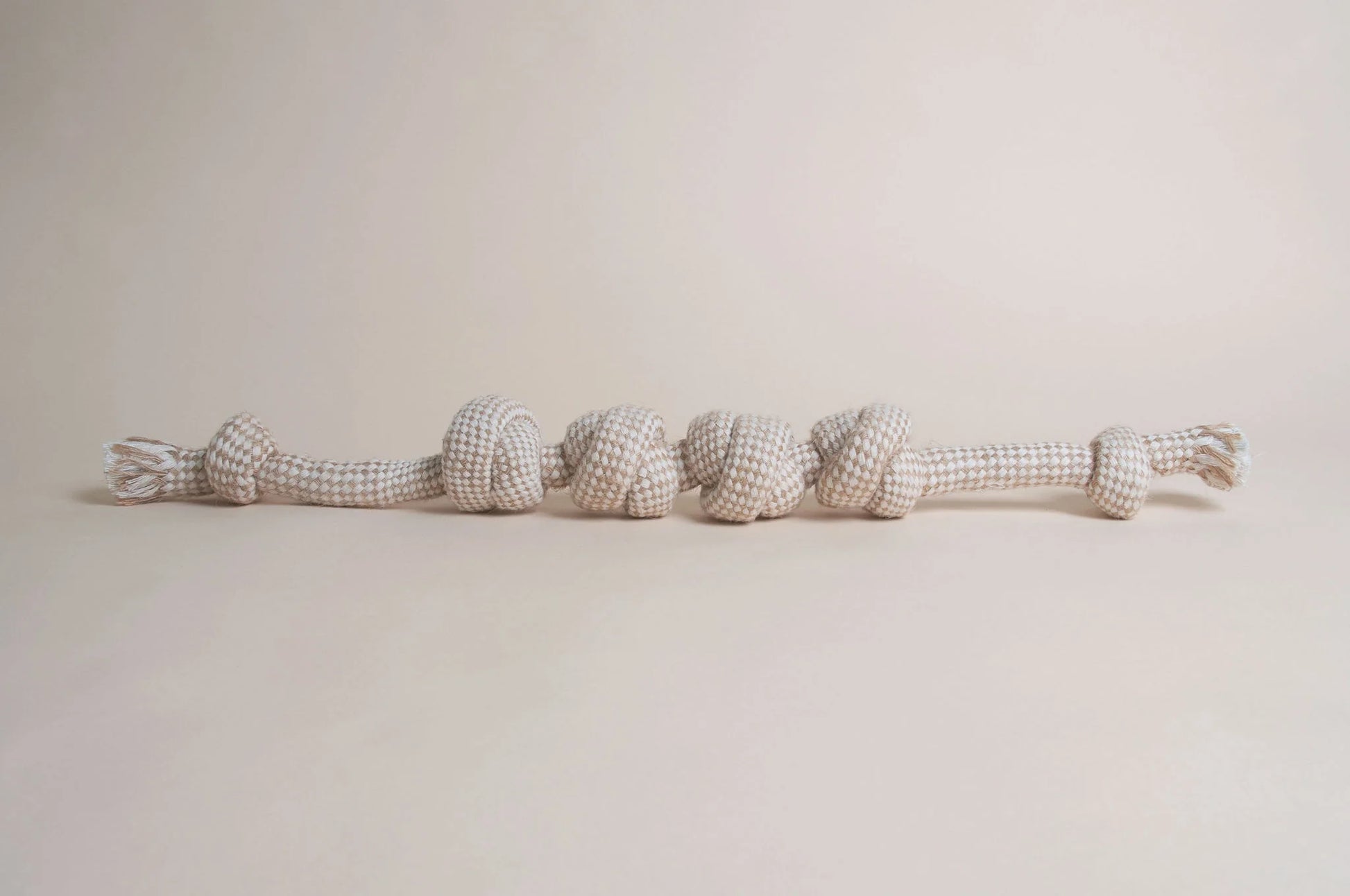 The Hilltop Pet Food Natural Rope Toy - Knotty But Nice Tug, in beige and white, sits on a neutral background.