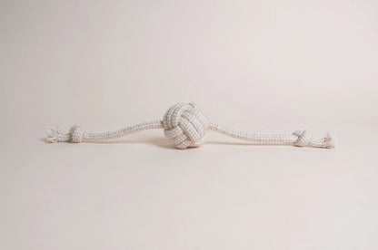 The Hilltop Pet Food Natural Rope Toy - Flail Ball is an eco-friendly knotted rope with a center ball and end knots.