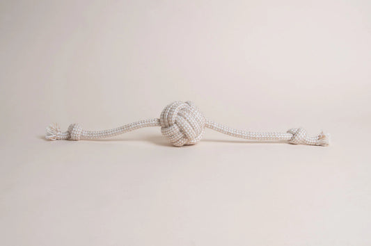 The Hilltop Pet Food Natural Rope Toy - Flail Ball is an eco-friendly knotted rope with a center ball and end knots.