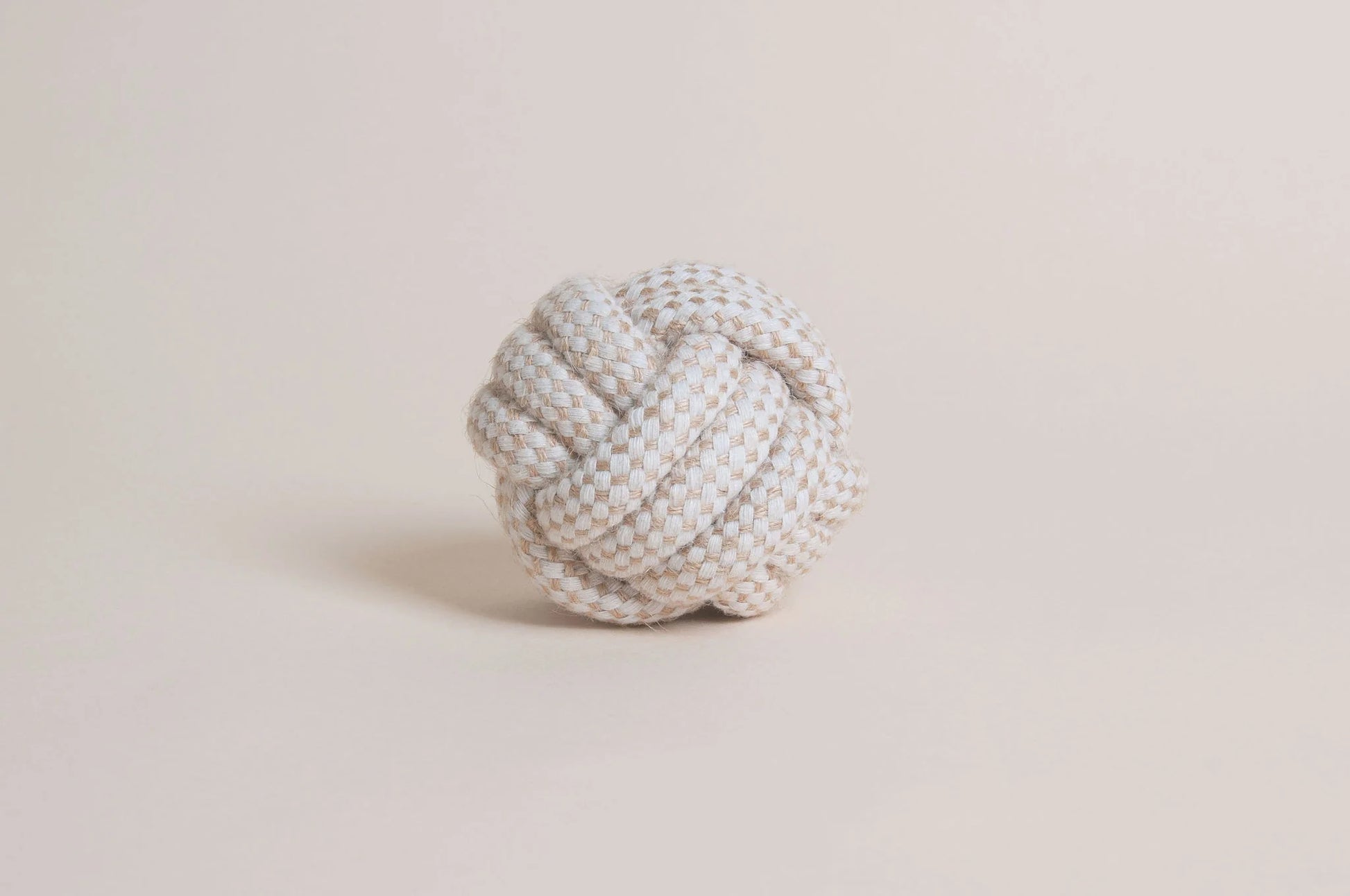 The Hilltop Pet Food Natural Rope Toy - Classic Rope Ball in white and beige rests on a plain light background.