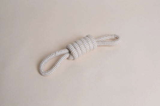 Hilltop Pet Food’s Natural Rope Toy - Bow Tie Tug, tied in a knot, shown on a light beige background.