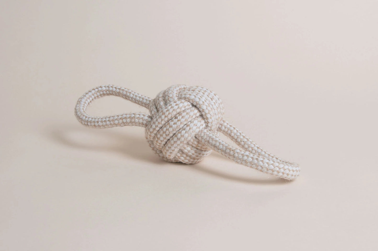 Hilltop Pet Foods Natural Rope Toy - Bow Tie Ball features a white and beige knot with two loose ends on a neutral background.