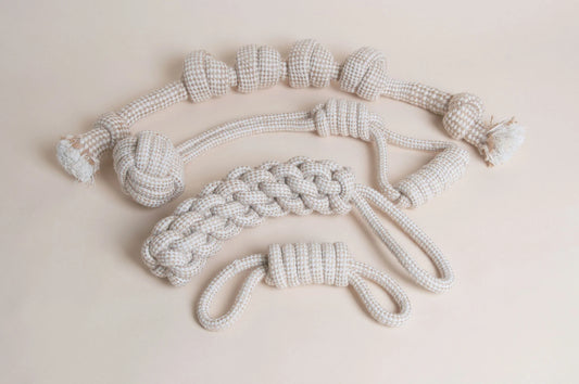Hilltop Pet Food Rope Toys - Tugs and Kisses: Set of 4 eco-friendly cream & white dog tug toys on a beige surface.