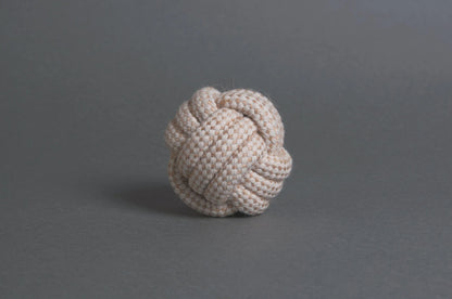 The Hilltop Pet Food Natural Rope Toy - Classic Rope Ball sits on a plain gray surface and background.