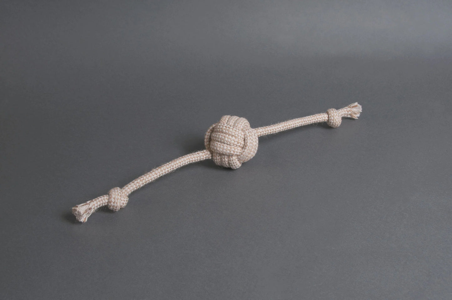 Hilltop Pet Foods Natural Rope Toy - Flail Ball in beige with frayed ends on a plain gray background.