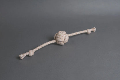 Hilltop Pet Foods Natural Rope Toy - Flail Ball in beige with frayed ends on a plain gray background.