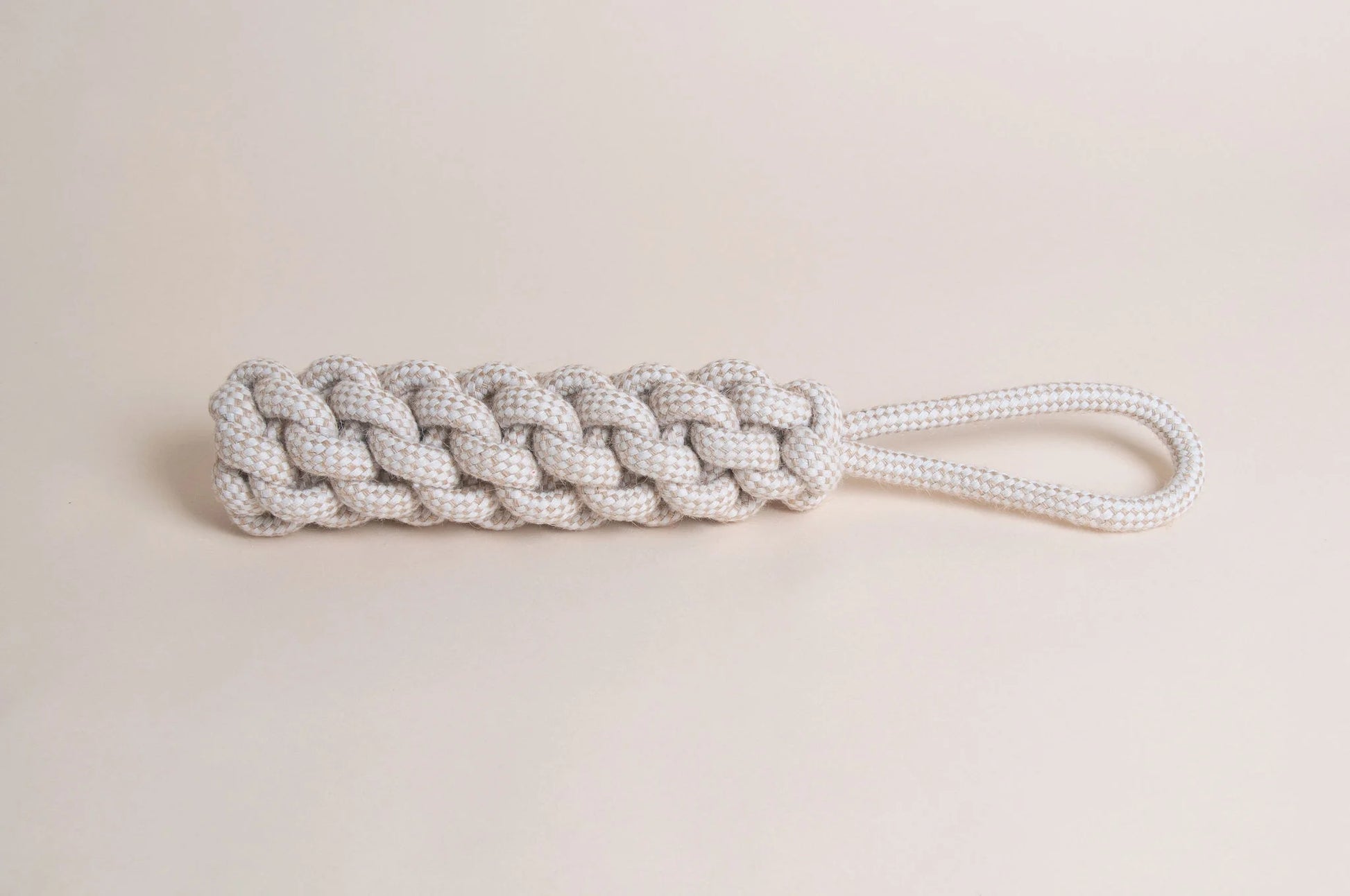 The Hilltop Pet Food Natural Rope Toy - Thug Tug with a looped handle rests on a light beige background.