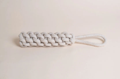 The Hilltop Pet Food Natural Rope Toy - Thug Tug with a looped handle rests on a light beige background.