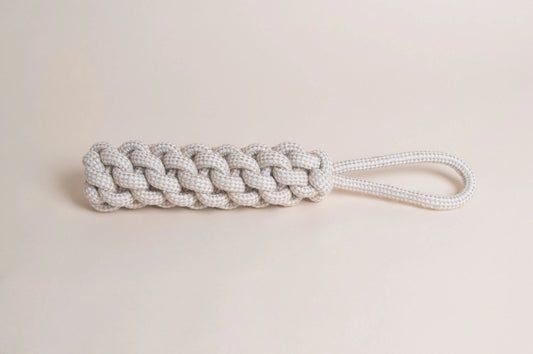 The Hilltop Pet Food Natural Rope Toy - Thug Tug with a looped handle rests on a light beige background.
