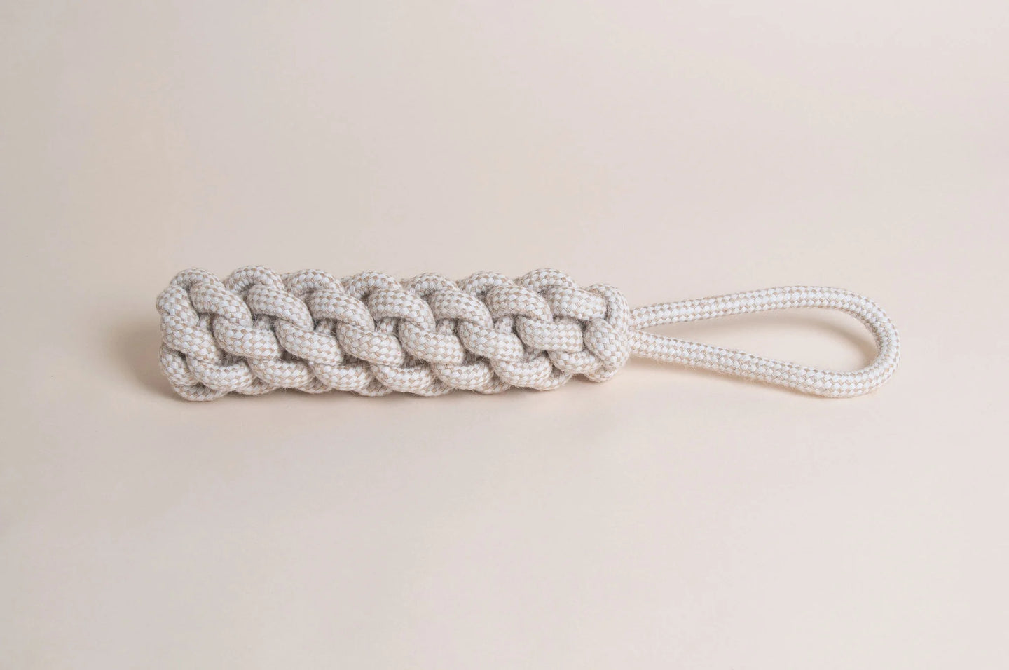 The Hilltop Pet Food Natural Rope Toy - Thug Tug with a looped handle rests on a light beige background.