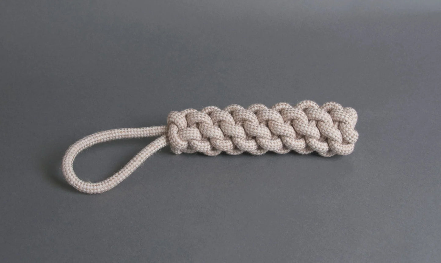 The Hilltop Pet Food Natural Rope Toy - Thug Tug is a beige loop-handle keychain inspired by organic dog toys.