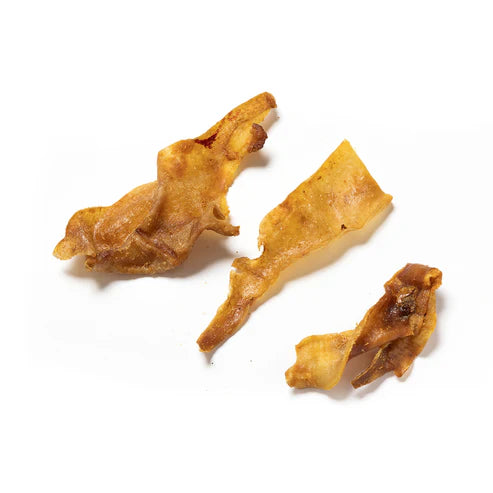 Three golden-brown Hilltop Pet Food Pork Rind Pieces on a white background.